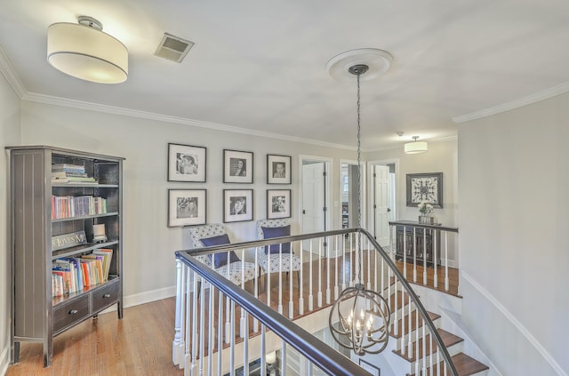 hall with wood-type flooring and crown molding