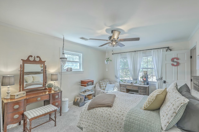 carpeted bedroom with crown molding and ceiling fan