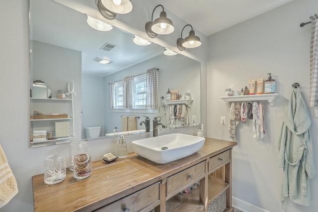 bathroom with vanity and toilet