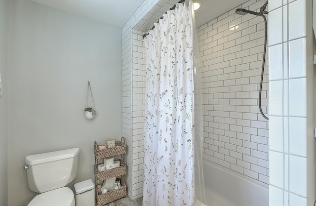 bathroom with toilet and shower / bath combo with shower curtain