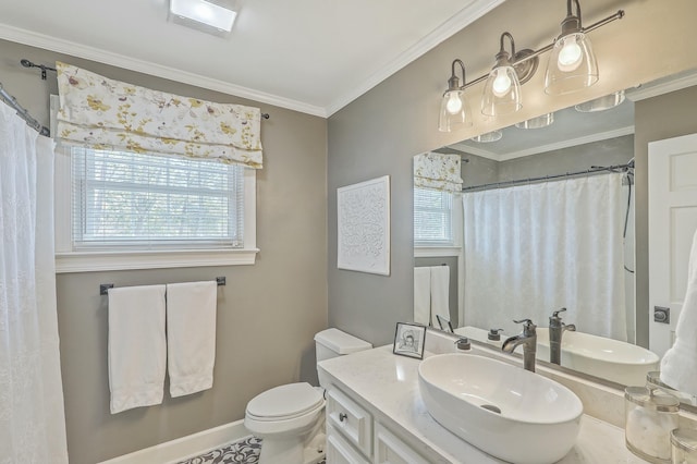 bathroom with ornamental molding, a wealth of natural light, vanity, and toilet