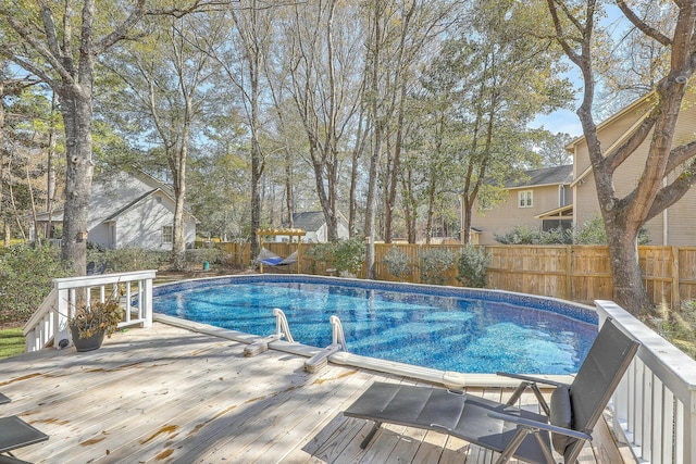 view of swimming pool with a wooden deck