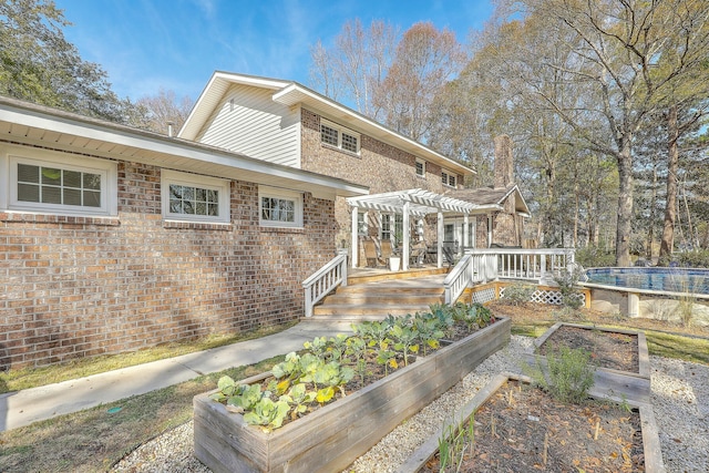 rear view of property featuring a pergola