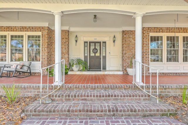 view of exterior entry with a porch