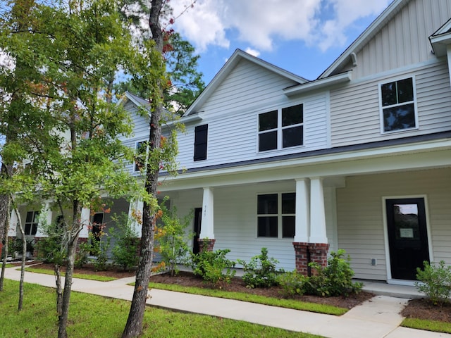 view of property featuring board and batten siding and covered porch