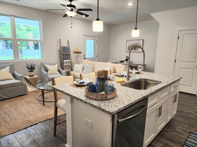 kitchen with open floor plan, stainless steel dishwasher, dark wood-style floors, white cabinetry, and a sink