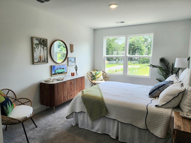 carpeted bedroom featuring visible vents