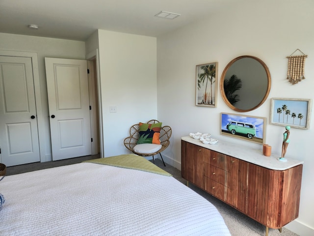 bedroom with visible vents, baseboards, and light colored carpet