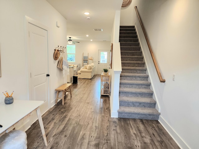 staircase featuring visible vents, a ceiling fan, wood finished floors, recessed lighting, and baseboards