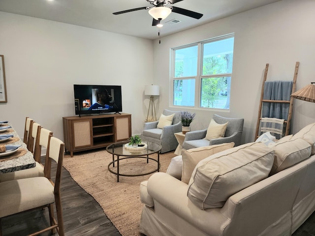 living room with visible vents, ceiling fan, and wood finished floors