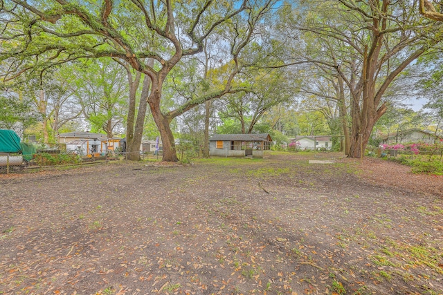1188 Camden St, North Charleston, SC 29405 - view of yard featuring an outdoor structure and fence