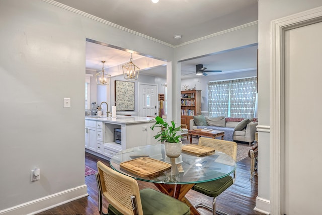 1188 Camden St, North Charleston, SC 29405 - dining space with baseboards, ornamental molding, ceiling fan with notable chandelier, and dark wood finished floors