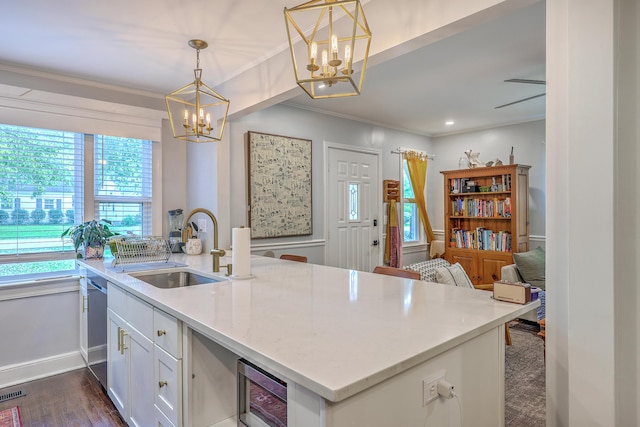 1188 Camden St, North Charleston, SC 29405 - kitchen featuring a notable chandelier, a sink, ornamental molding, wine cooler, and white cabinetry