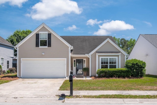 traditional-style house featuring driveway, a front lawn, and a garage