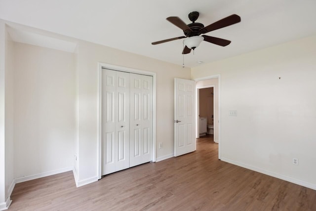 unfurnished bedroom with light wood-type flooring, baseboards, and a closet