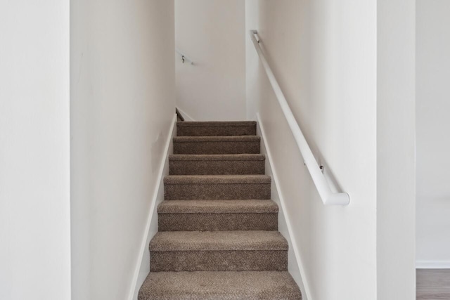 staircase featuring baseboards