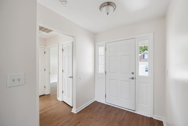 foyer entrance featuring wood finished floors and baseboards