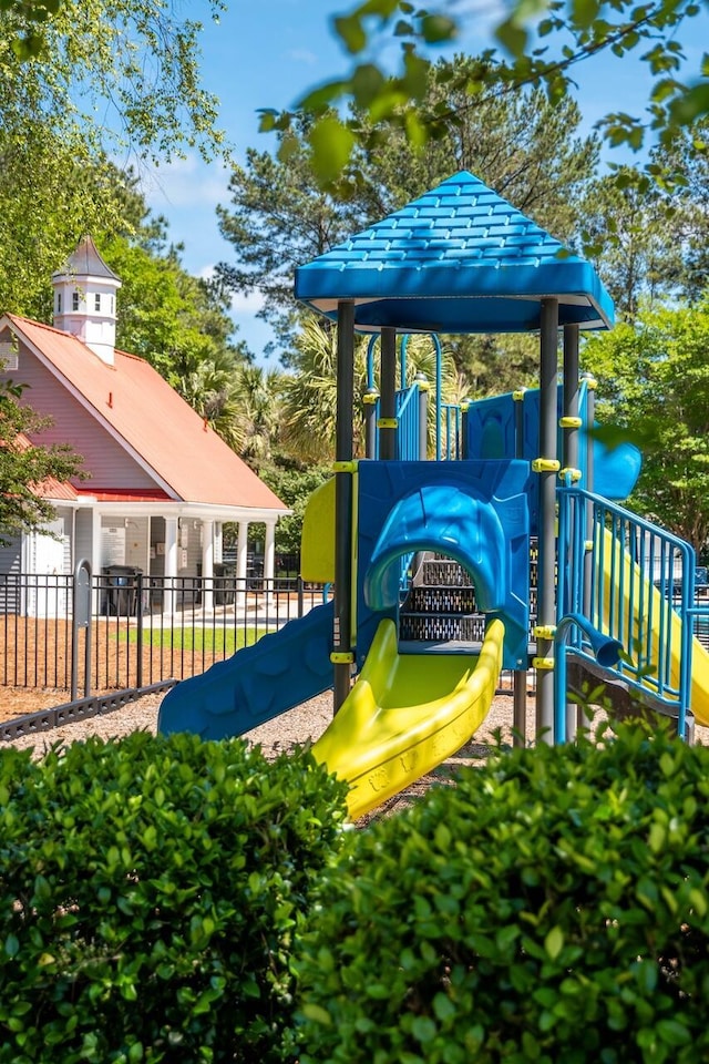 view of jungle gym featuring fence