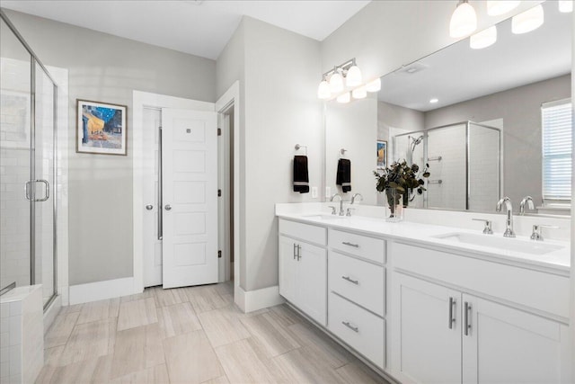 bathroom with a shower with door and vanity