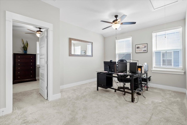 carpeted home office featuring ceiling fan