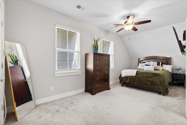 bedroom featuring vaulted ceiling, light carpet, and ceiling fan