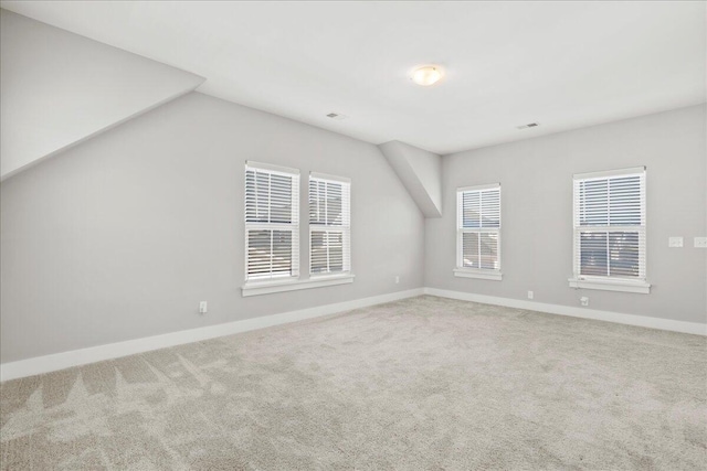 bonus room with lofted ceiling and carpet floors