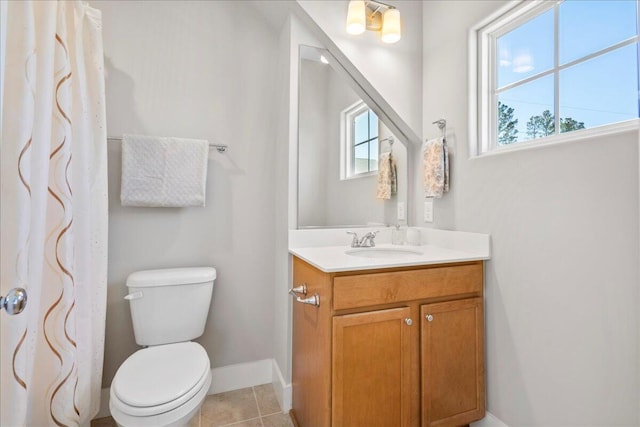 bathroom with tile patterned flooring, vanity, and toilet