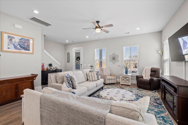 living room featuring ceiling fan and light hardwood / wood-style flooring