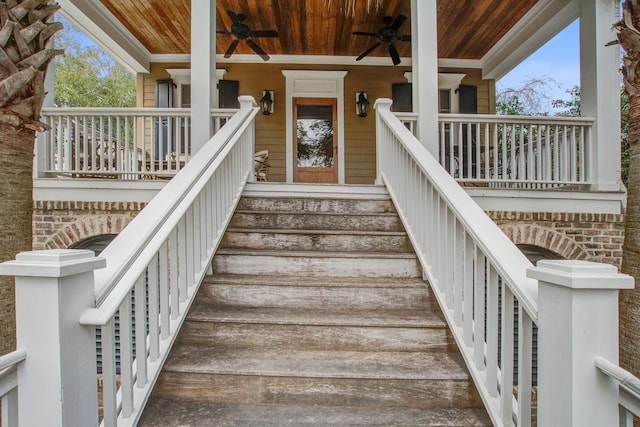 entrance to property featuring ceiling fan and a porch