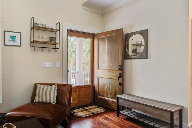 doorway to outside with dark wood-style floors and ornamental molding