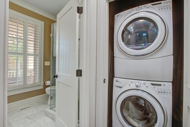 laundry room featuring laundry area, visible vents, marble finish floor, stacked washing maching and dryer, and crown molding