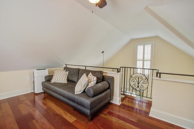 living area with vaulted ceiling, wood finished floors, an upstairs landing, and baseboards