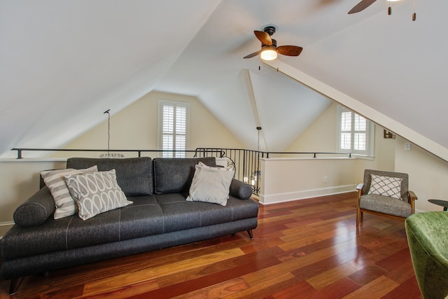 living area featuring lofted ceiling, ceiling fan, baseboards, and wood finished floors