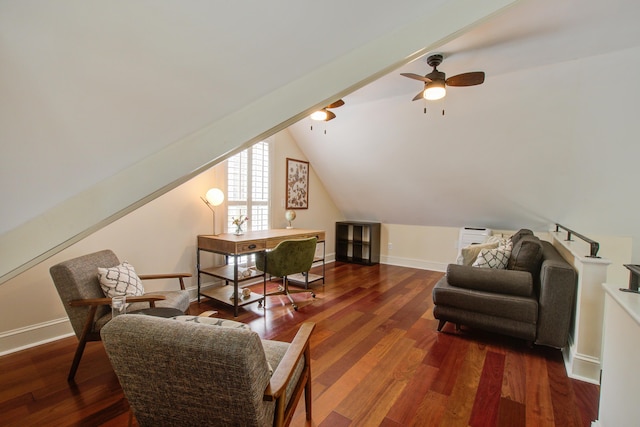 living area featuring lofted ceiling, baseboards, and wood finished floors