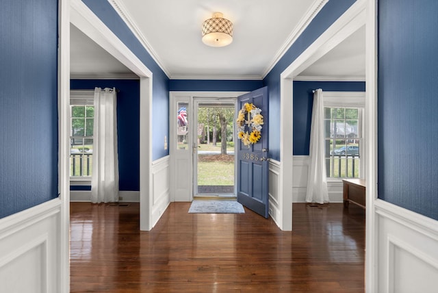 foyer with wood-type flooring and ornamental molding