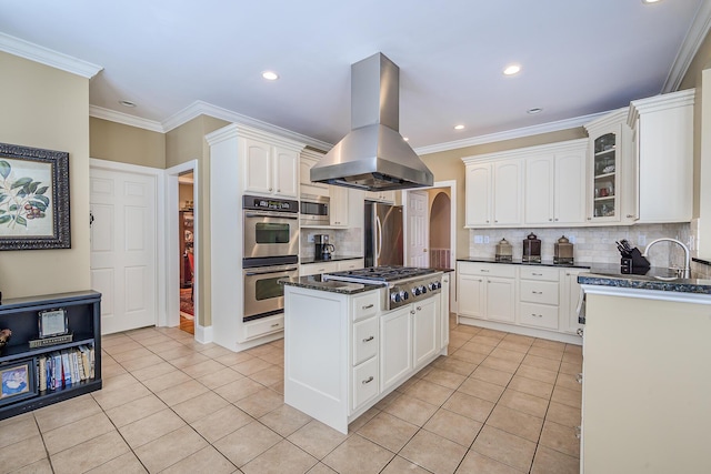 kitchen featuring appliances with stainless steel finishes, light tile patterned flooring, white cabinets, and island range hood