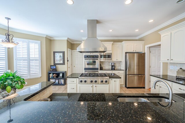 kitchen with stainless steel appliances, light tile patterned flooring, a sink, and dark stone countertops