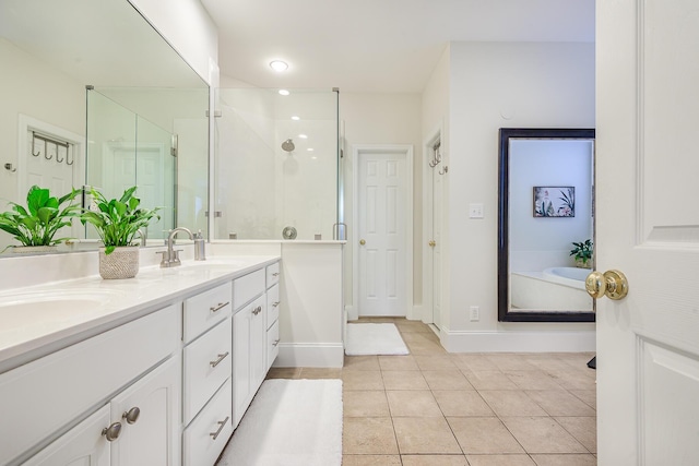 full bathroom featuring double vanity, a sink, a shower stall, and tile patterned floors