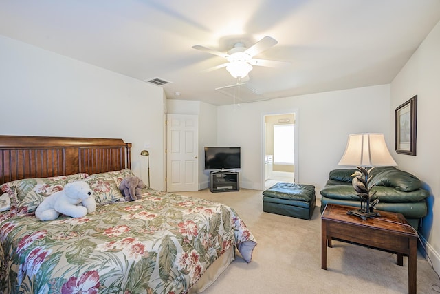 bedroom with light carpet, attic access, visible vents, baseboards, and a ceiling fan