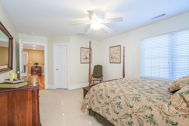 bedroom featuring ceiling fan, baseboards, visible vents, and light colored carpet