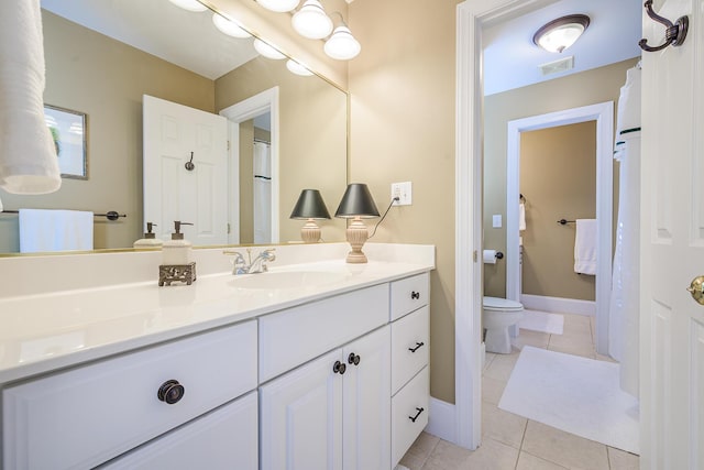 full bathroom featuring tile patterned flooring, toilet, vanity, visible vents, and baseboards