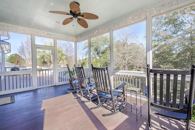 sunroom with plenty of natural light and a ceiling fan