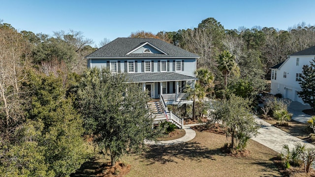 view of front of property with stairs, concrete driveway, and a porch