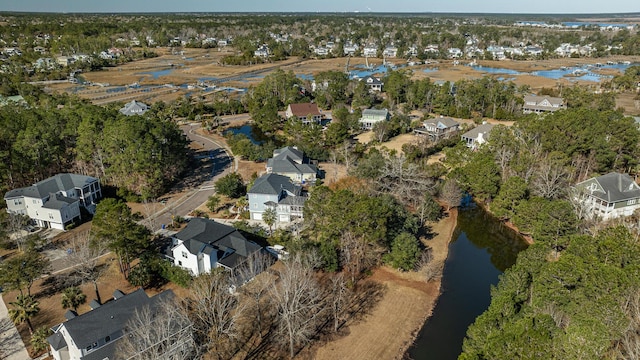 drone / aerial view featuring a water view and a residential view