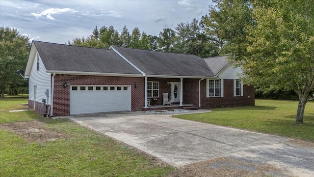 view of front of house with a porch, a front lawn, and a garage