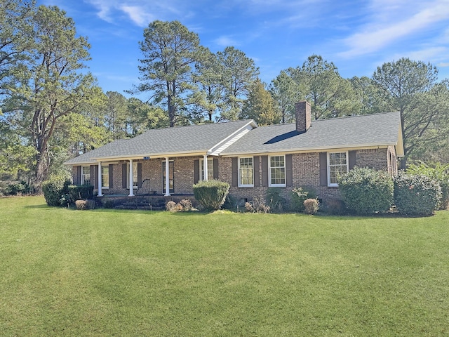 ranch-style house with covered porch, brick siding, crawl space, a chimney, and a front yard