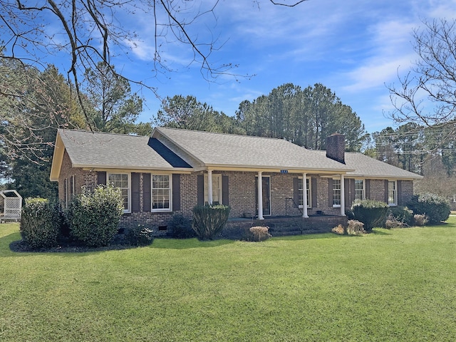 ranch-style house with roof with shingles, a front yard, a chimney, and brick siding