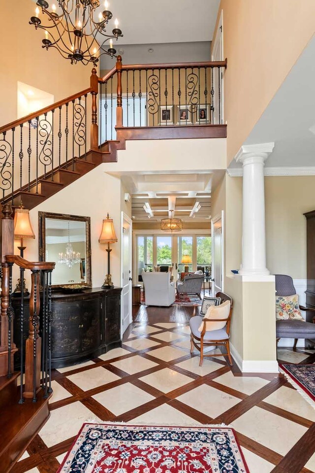 2636 Anchor Watch Dr, Wadmalaw Island, SC 29487 - foyer entrance featuring stairs, ornamental molding, an inviting chandelier, a high ceiling, and baseboards