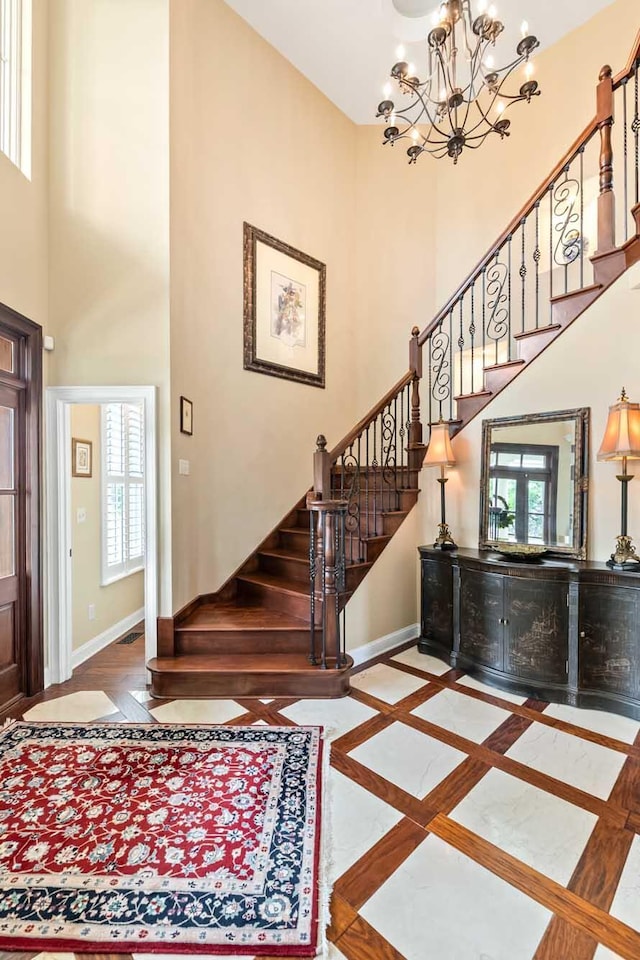 2636 Anchor Watch Dr, Wadmalaw Island, SC 29487 - foyer entrance featuring a notable chandelier, baseboards, a towering ceiling, and stairs