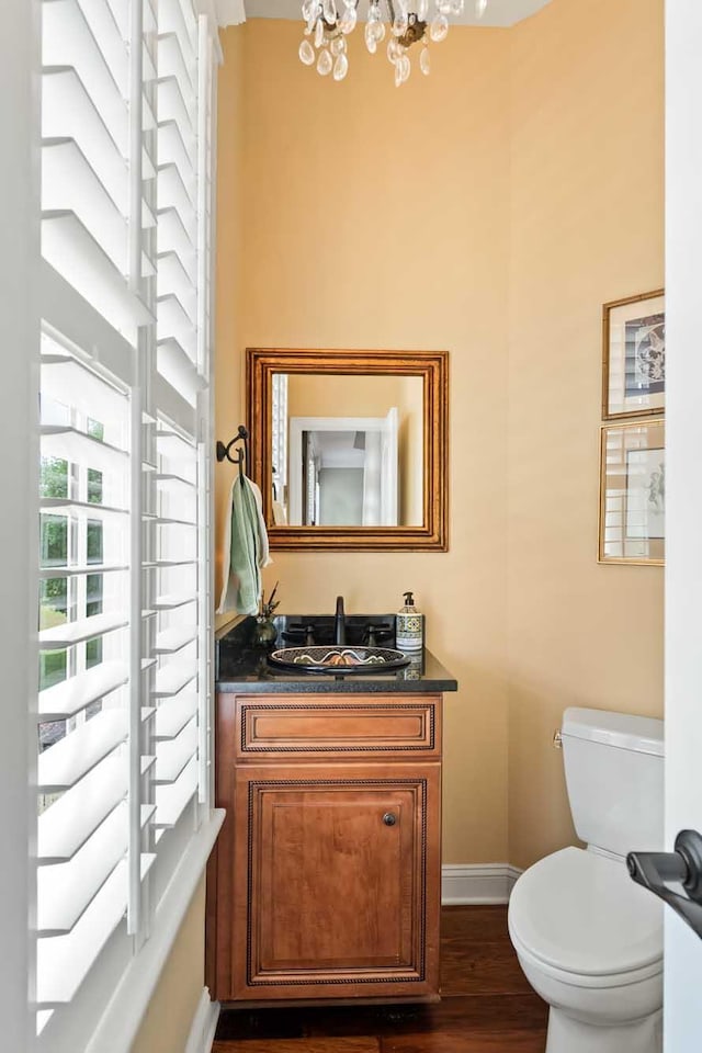 2636 Anchor Watch Dr, Wadmalaw Island, SC 29487 - bathroom with an inviting chandelier, toilet, wood finished floors, baseboards, and vanity